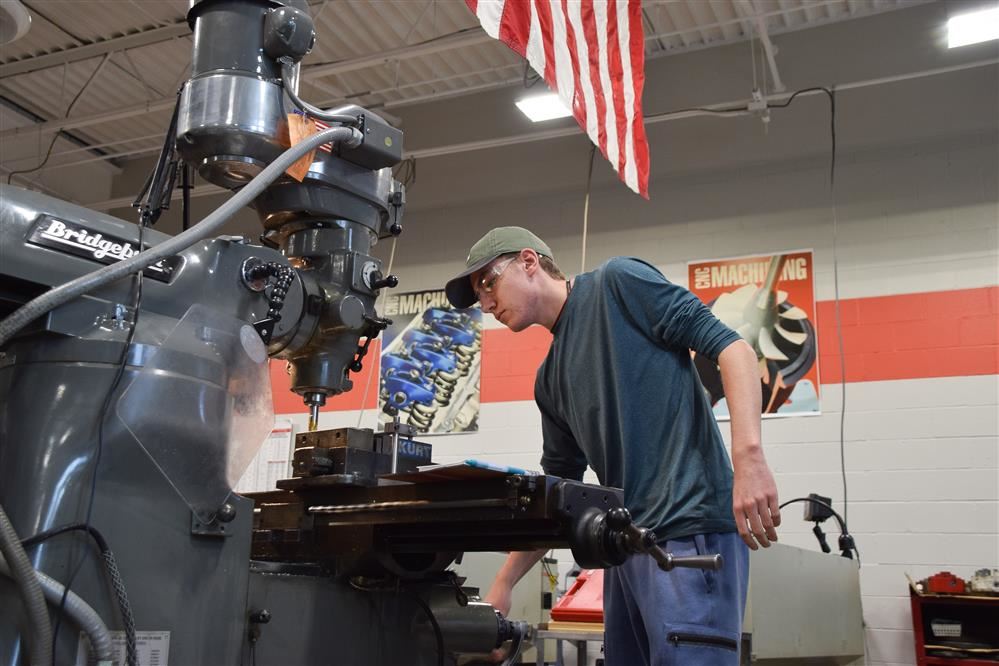 Student works in the shop. Student works in the shop.