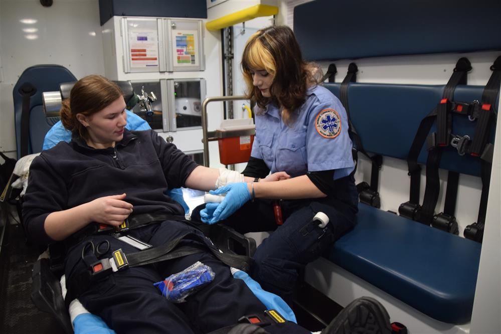 Emergency Services students practice safely moving a volunteer "patient"