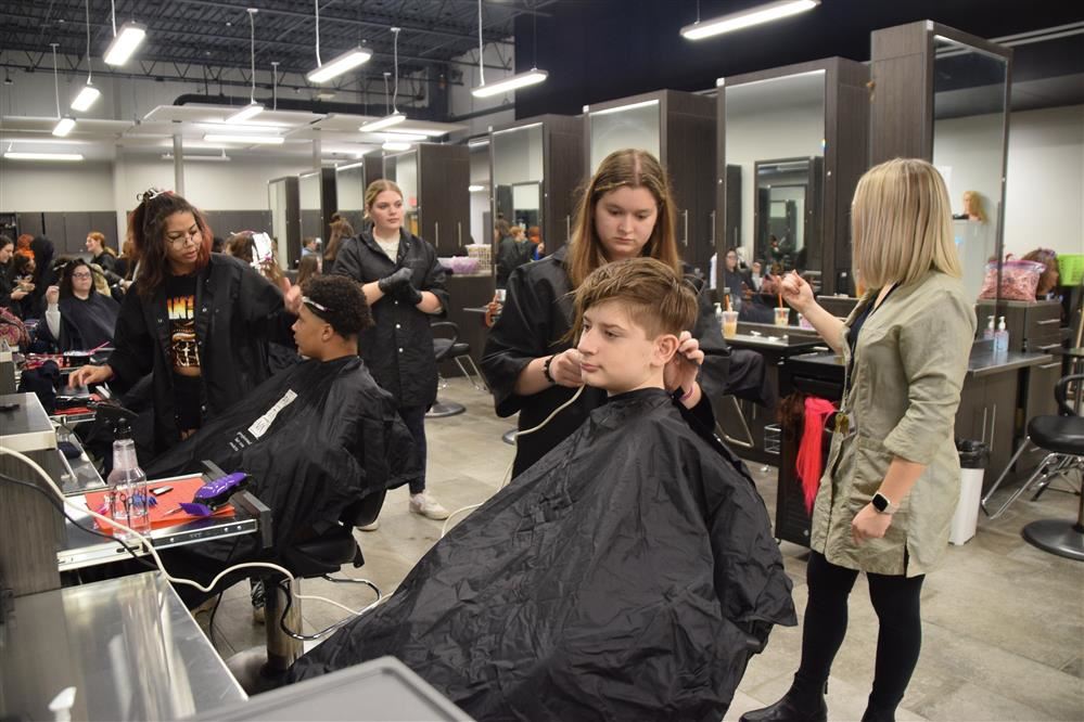 Cosmetology students cut hair. Cosmetology students cut hair.